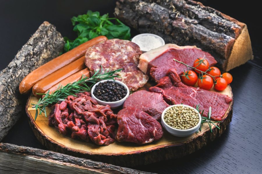 sliced meat on brown wooden round plate